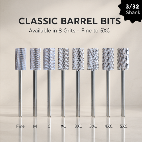 Set of eight cylindrical metal carbide bits with different grits on a beige background for nail technician professional use