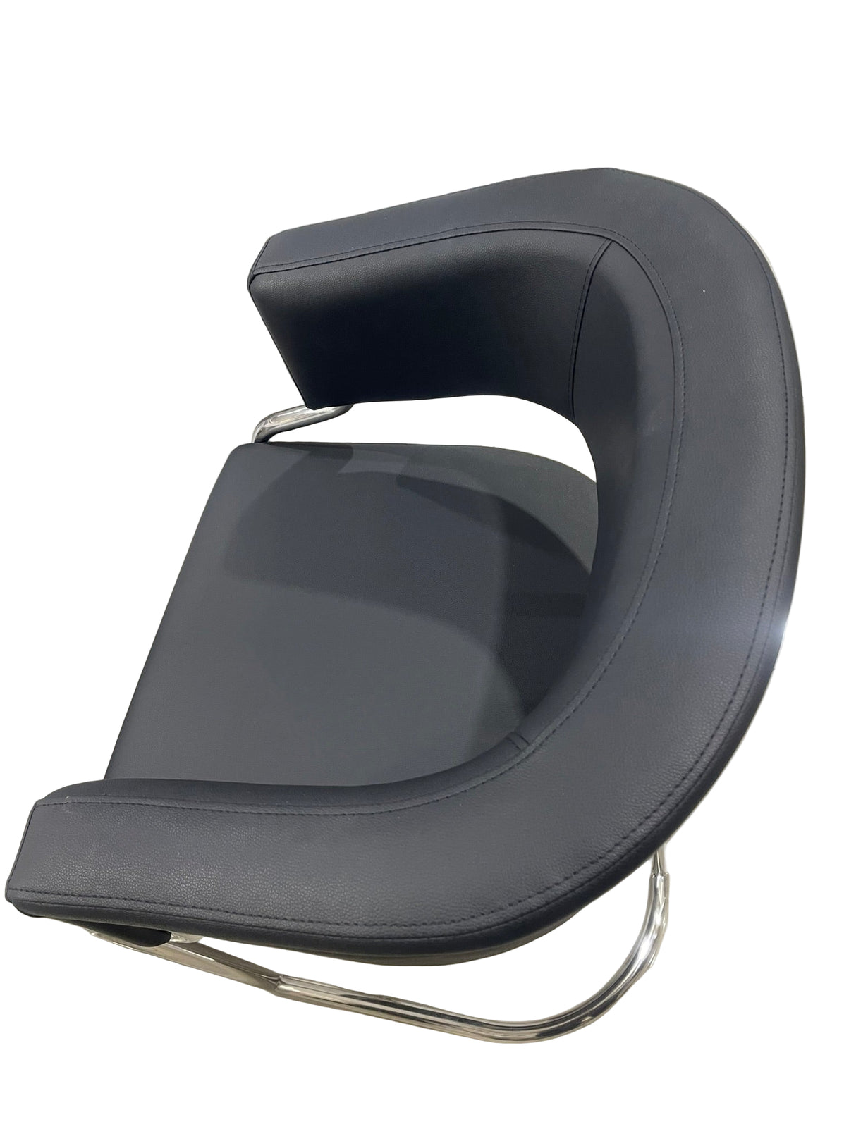 Modern black chair with a curved design on a wooden floor.