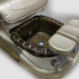 Close-up of a vehicle seat with a textured surface and visible wear, surrounded by cardboard boxes.