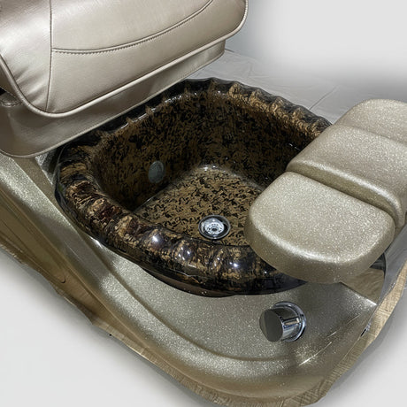 Close-up of a vehicle seat with a textured surface and visible wear, surrounded by cardboard boxes.