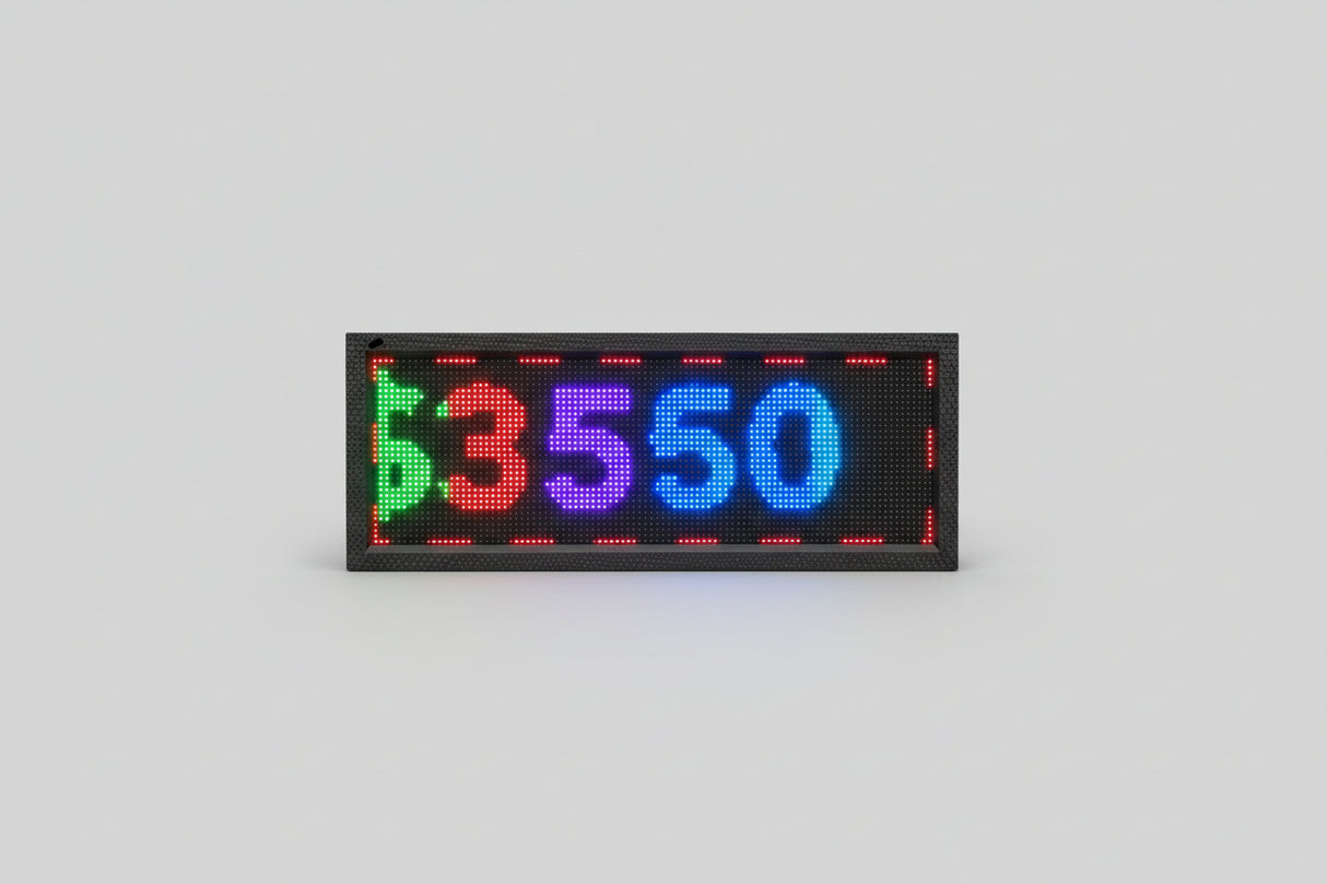 Digital display with LED numbers and symbols on a wall.