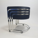 Stack of black and chrome bar stools in a store setting